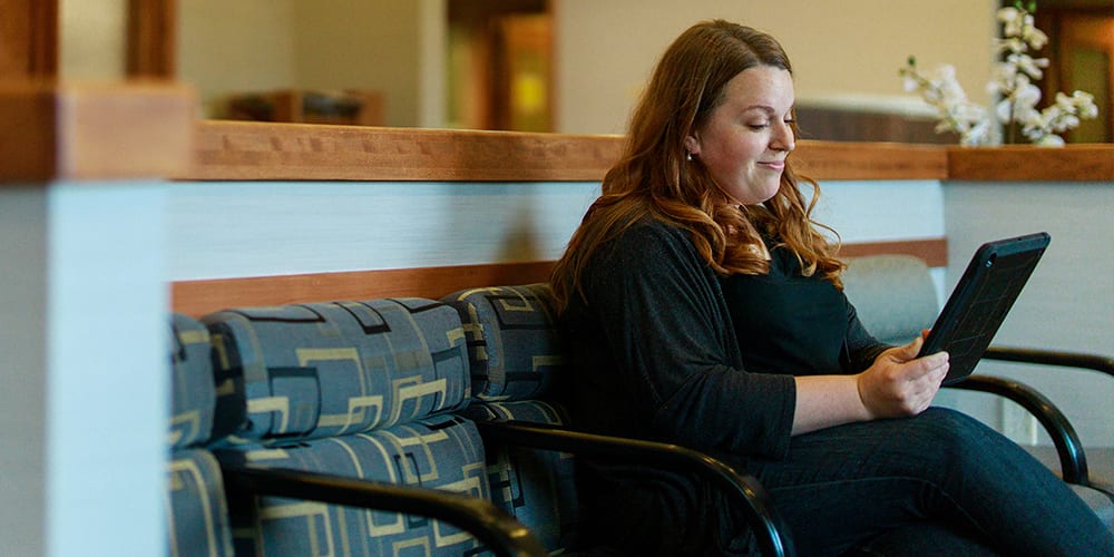 woman using a tablet to read 